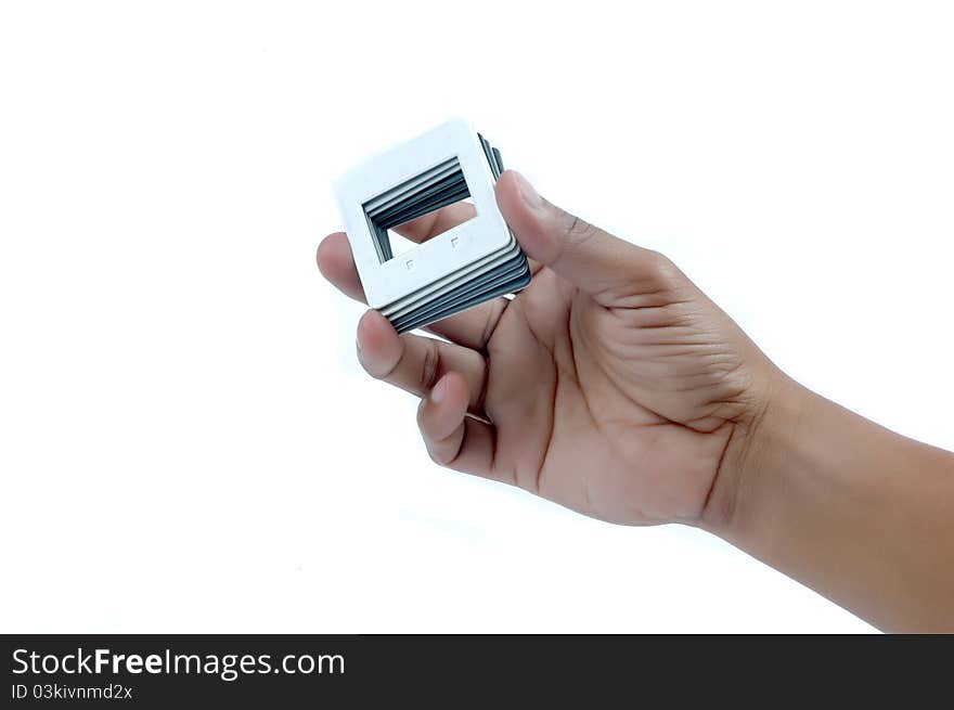 Male hand holding a pile of frames film slide isolated on white background