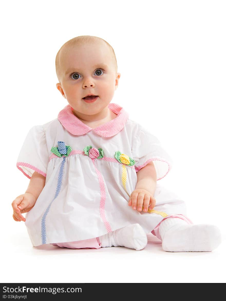 Baby in dress on a white background.