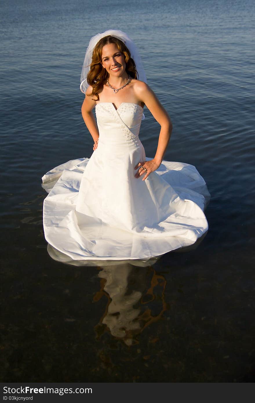 A bride getting bridal gown wet. A bride getting bridal gown wet