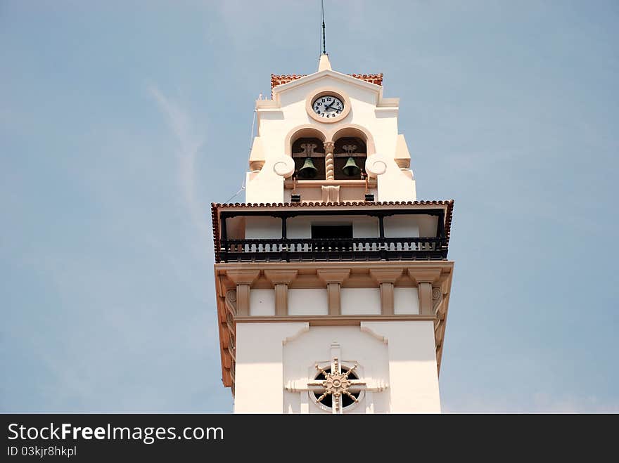 Broach spire and a blue sky, white on a blue, clock. Broach spire and a blue sky, white on a blue, clock