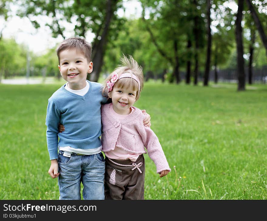 Happy sister and brother outdoors