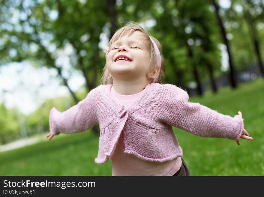 Portrait of a happy little girl in the park. Portrait of a happy little girl in the park