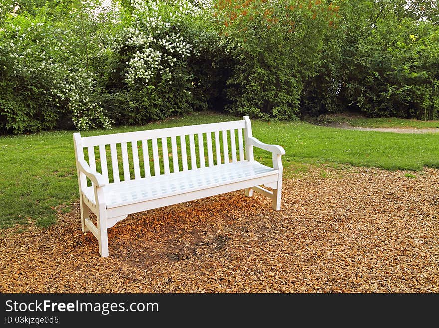 Empty white wooden bench in park. Empty white wooden bench in park