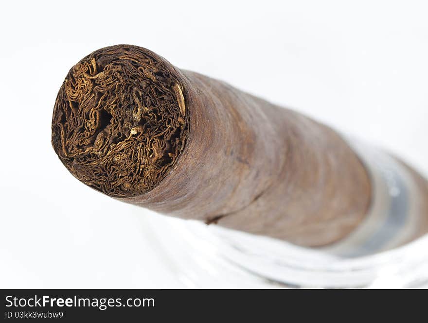 Cut side of expensive hand-rolled cigar on a while background