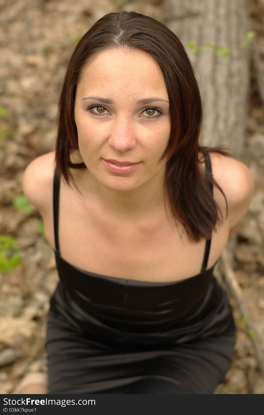 Female sitting on a log in the forest