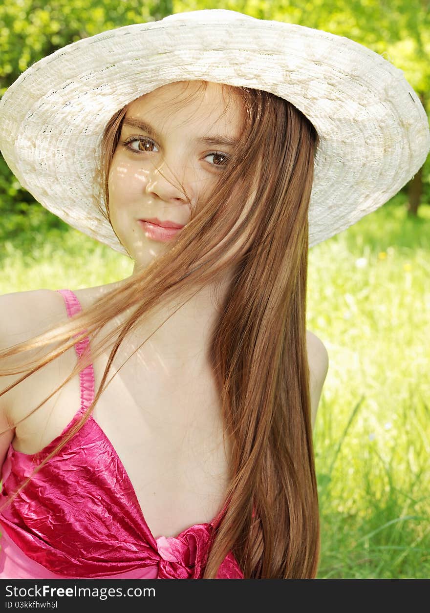 Young girl in the hat with the moving hair