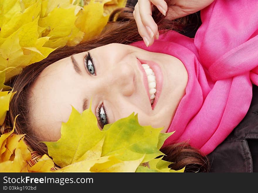 Beautiful woman in the autumnal garland from leaves. Beautiful woman in the autumnal garland from leaves