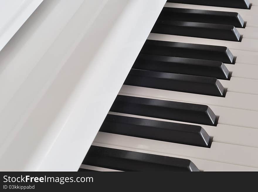 Beautiful white piano and keyboard. Beautiful white piano and keyboard