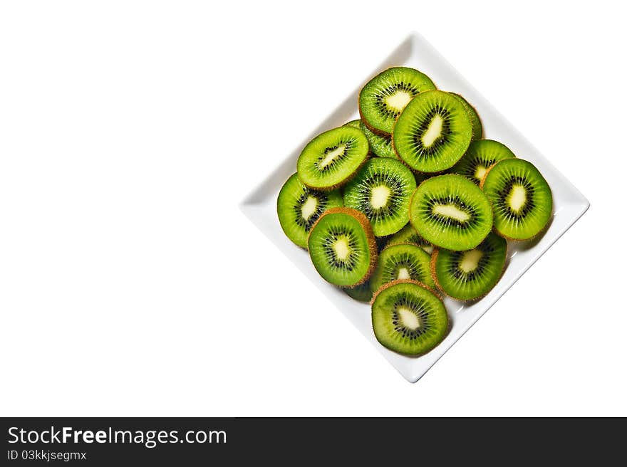 Kiwi fruit on a white plate and background.