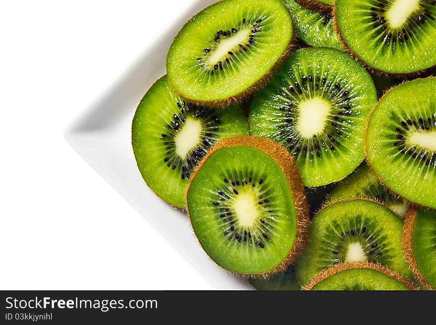 Kiwi fruit on a white plate and background.