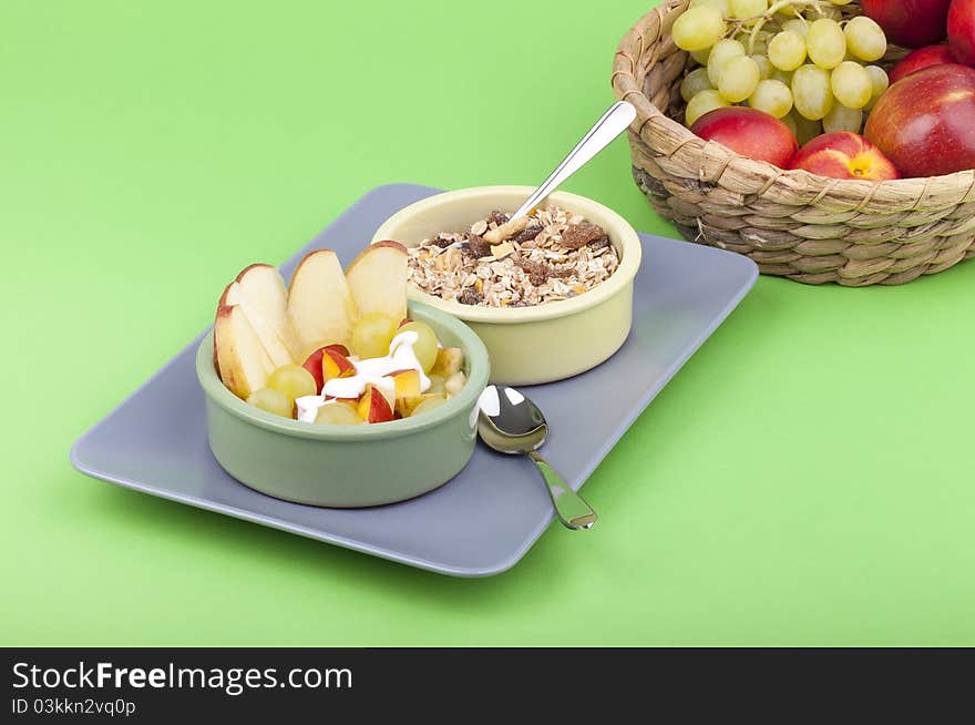 Studio-shot of a plate with fresh fruits, muesli and yogurt. bowl full with grapes, nectarines and apple. Studio-shot of a plate with fresh fruits, muesli and yogurt. bowl full with grapes, nectarines and apple.