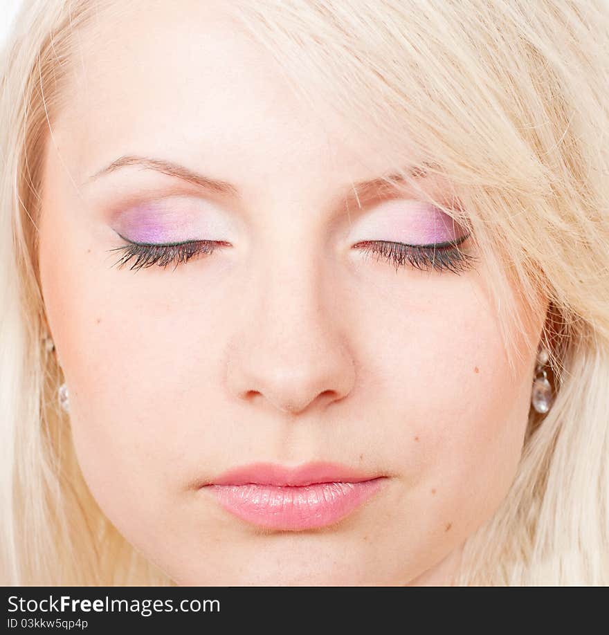 Beautiful blond girl with eyes closed and beautiful make-up