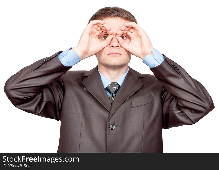 Concentrated businessman making binoculars with hands and looking through. Isolated on white