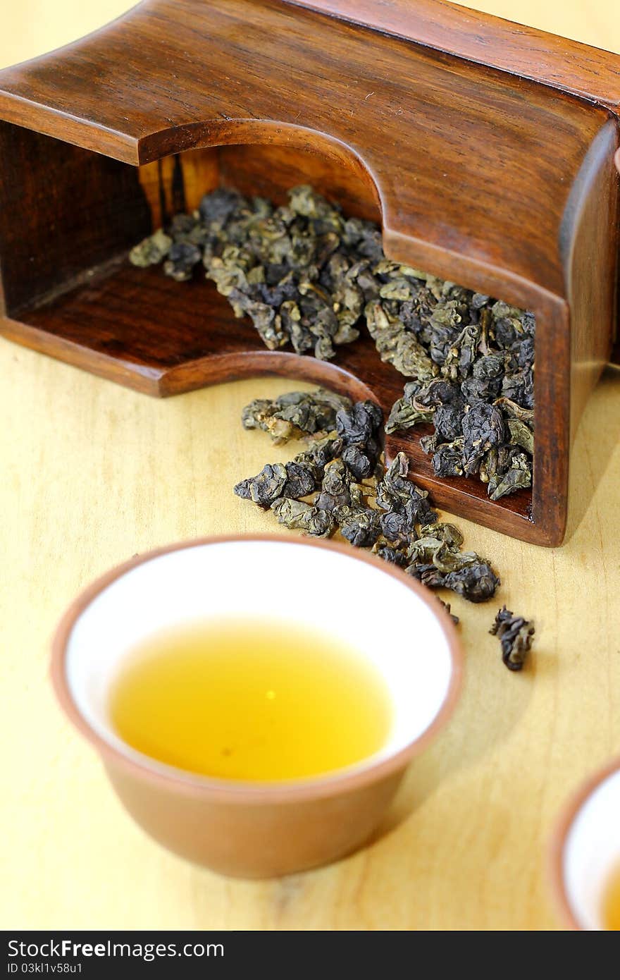 Quality dried Chinese tea leaves with freshly brewed drinks.