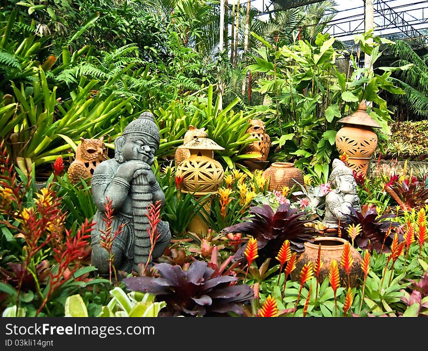 Various terracotta pottery between green plants