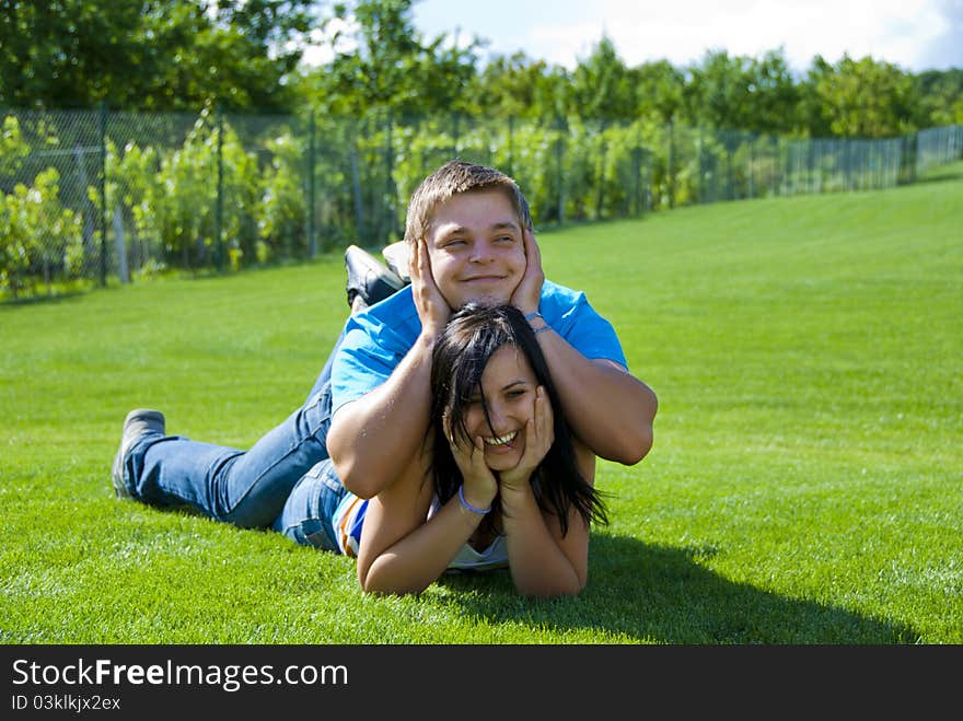 Two young people lying on the grass. Two young people lying on the grass