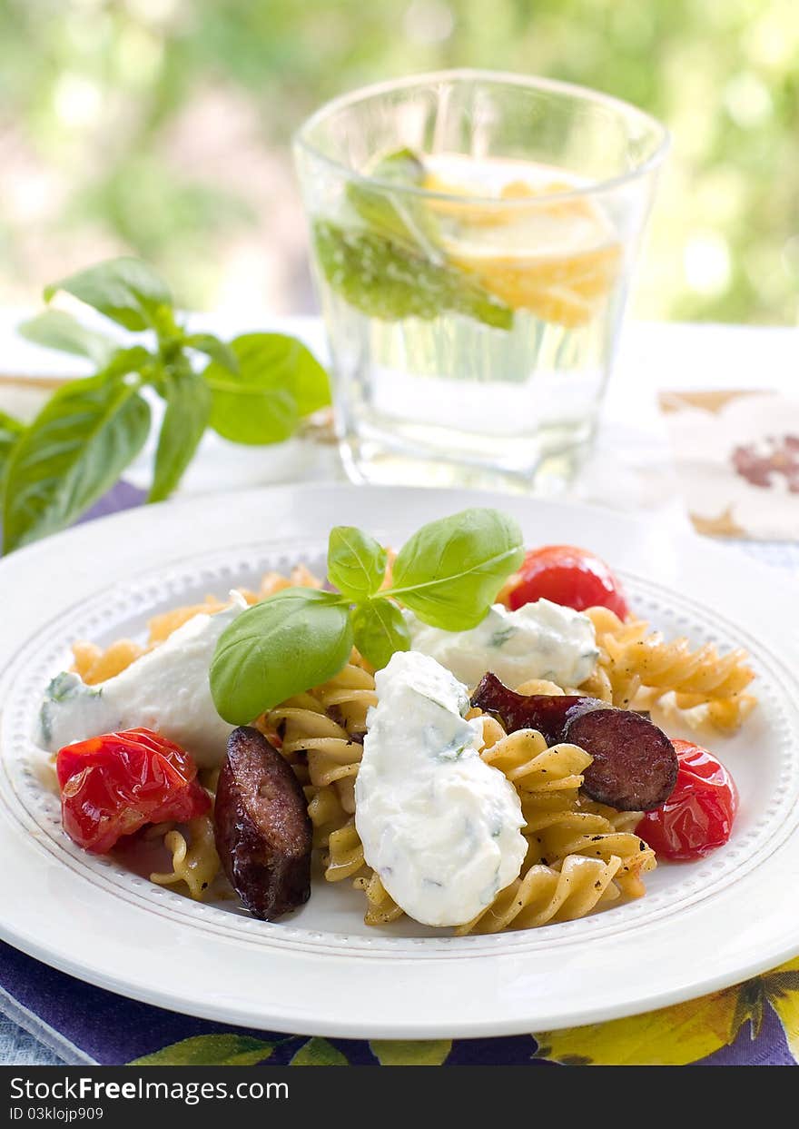 Fusilli with  tomatoes, sausage and cheese. Selective focus. Fusilli with  tomatoes, sausage and cheese. Selective focus