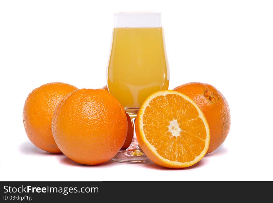 Close view of a bunch of oranges with glass of juice isolated on a white background. Close view of a bunch of oranges with glass of juice isolated on a white background