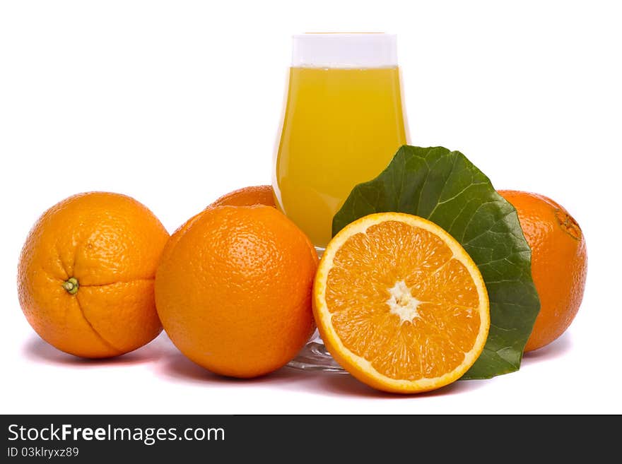 Close view of a bunch of oranges with glass of juice, isolated on a white background. Close view of a bunch of oranges with glass of juice, isolated on a white background