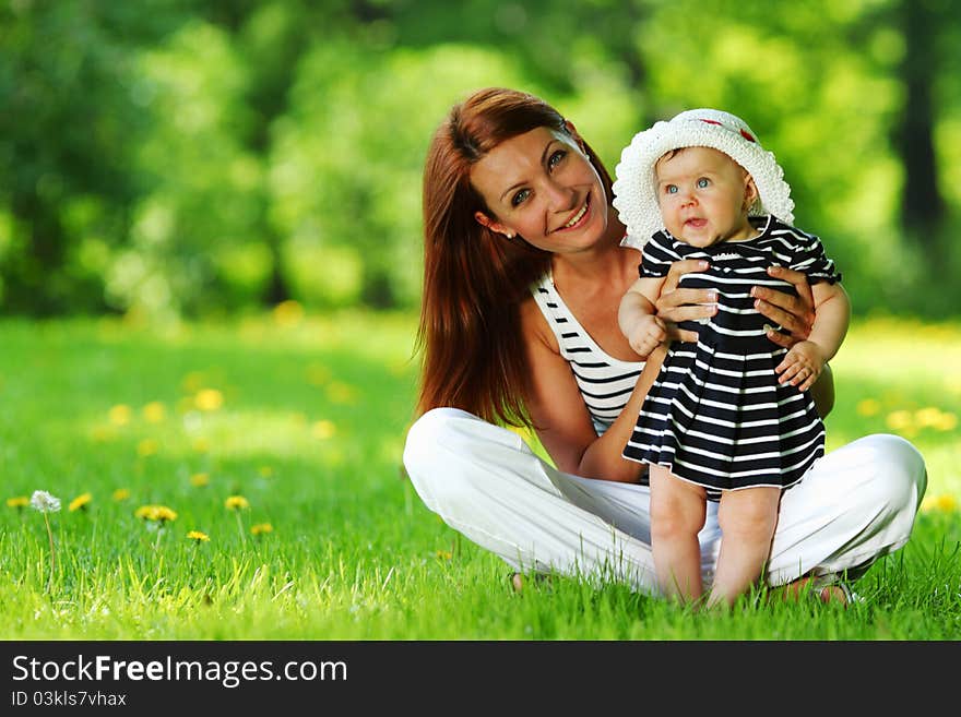 Mother and daughter on the green grass