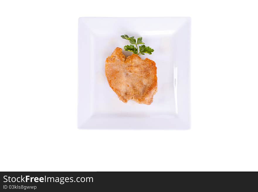 Chop in breadcrumbs. on a plate. on a white background. Chop in breadcrumbs. on a plate. on a white background.