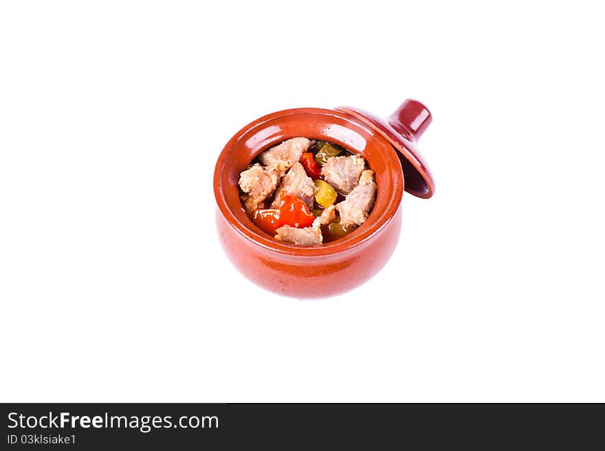 Meat with vegetables in a pot with a lid. On a white background. Meat with vegetables in a pot with a lid. On a white background.