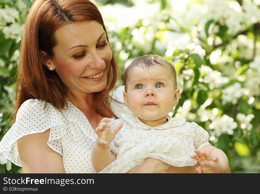 Mother and daughter close up portrait on flower background