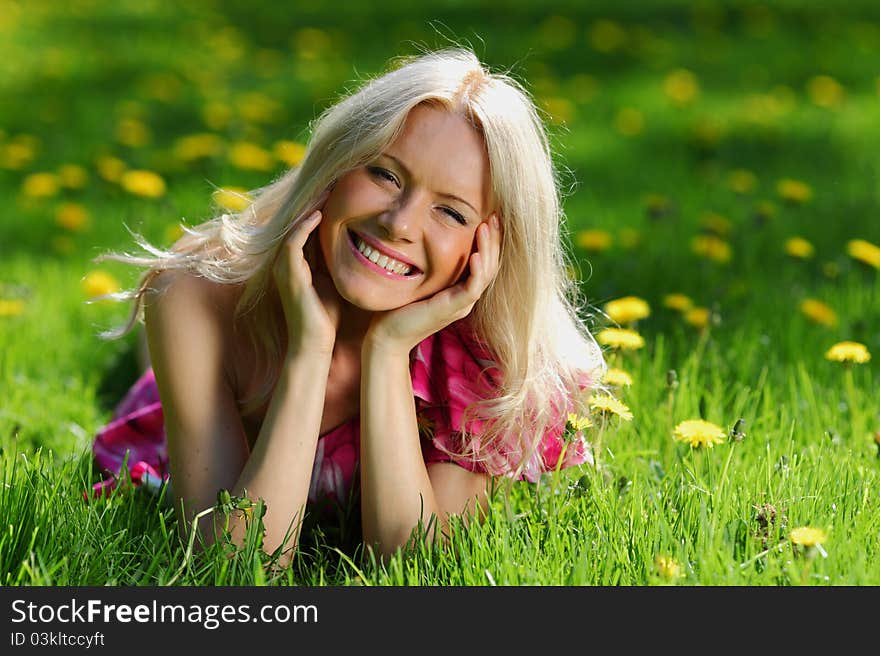 Girl lying on the field of dandelions. Girl lying on the field of dandelions