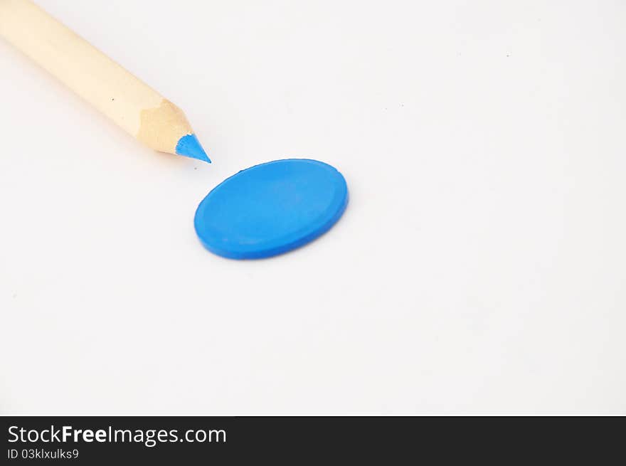 Blue pencil pointing at a blue water color disc. Blue pencil pointing at a blue water color disc.