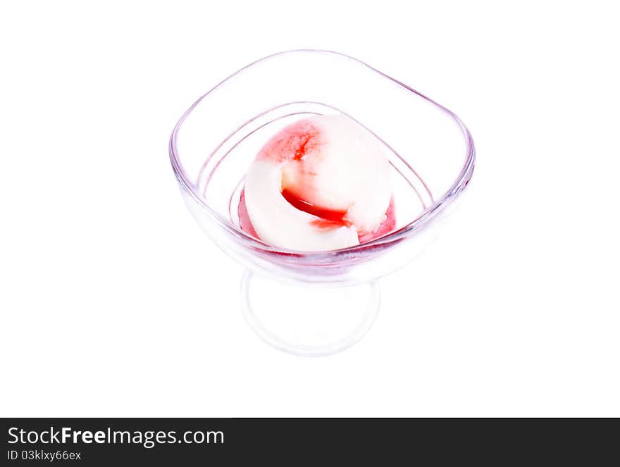 Strawberry ice cream in a glass beaker. On a white background