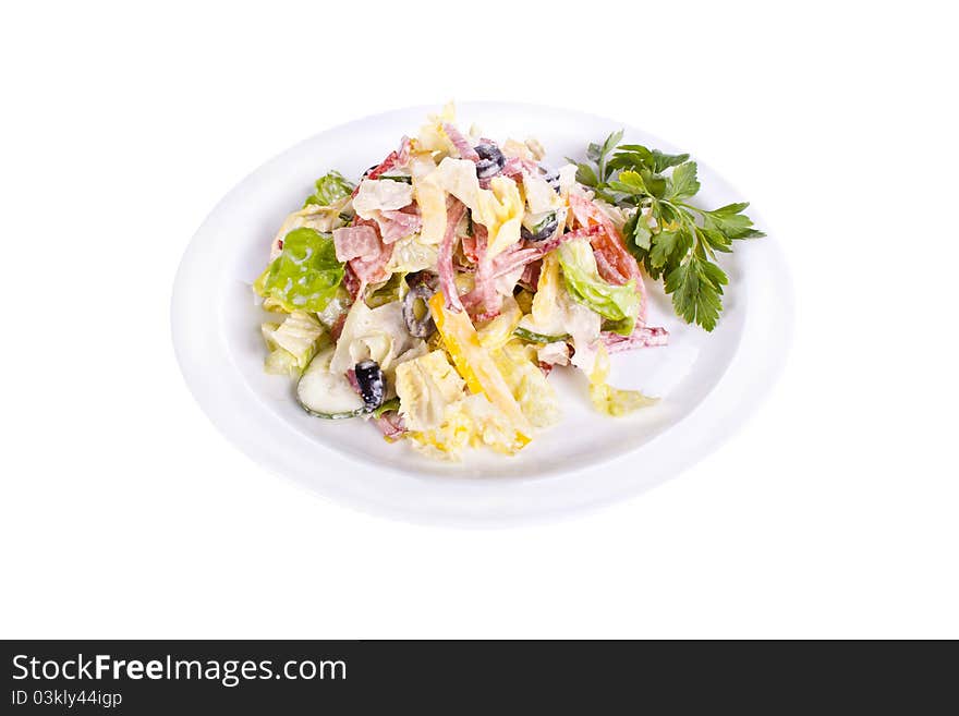 Salad of ham, bacon, tomatoes, cucumbers, olives on a plate. Salad of ham, bacon, tomatoes, cucumbers, olives on a plate.