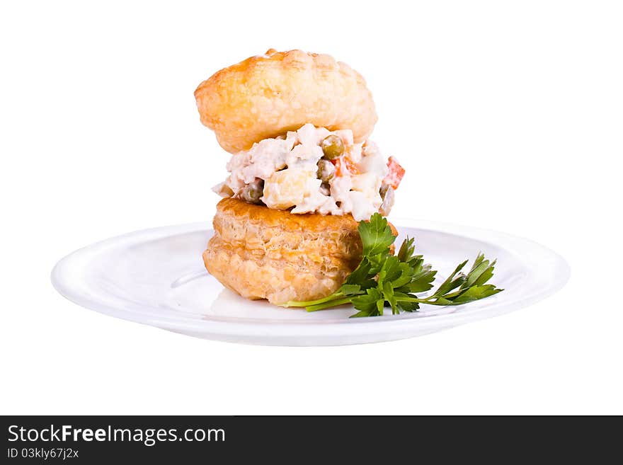 Plate with a tartlet filled with a salad. Plate with a tartlet filled with a salad.