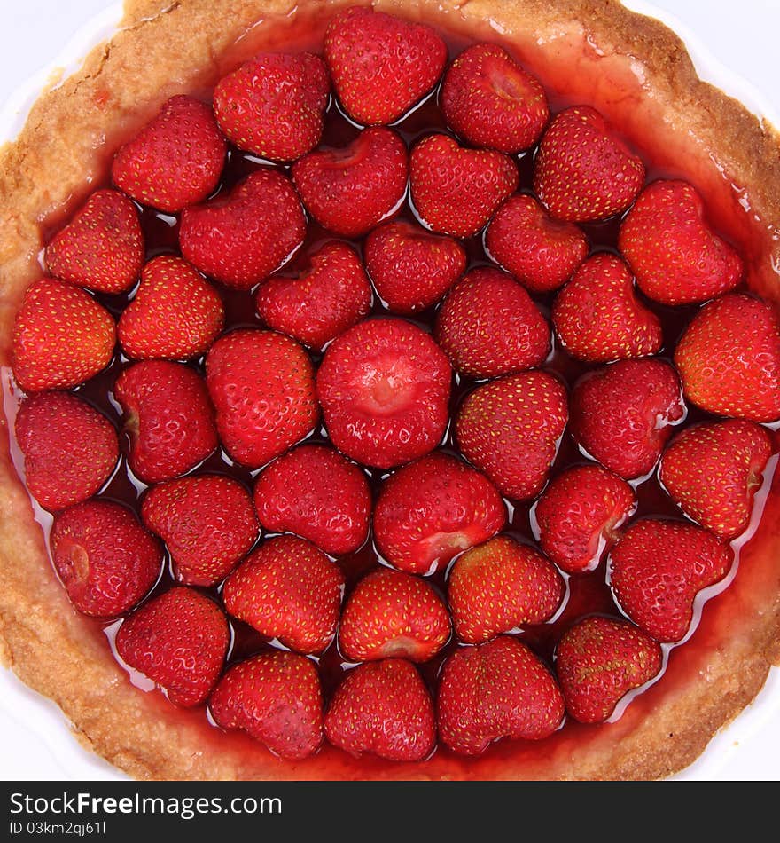 Strawberry Tart in a tart pan on a white background