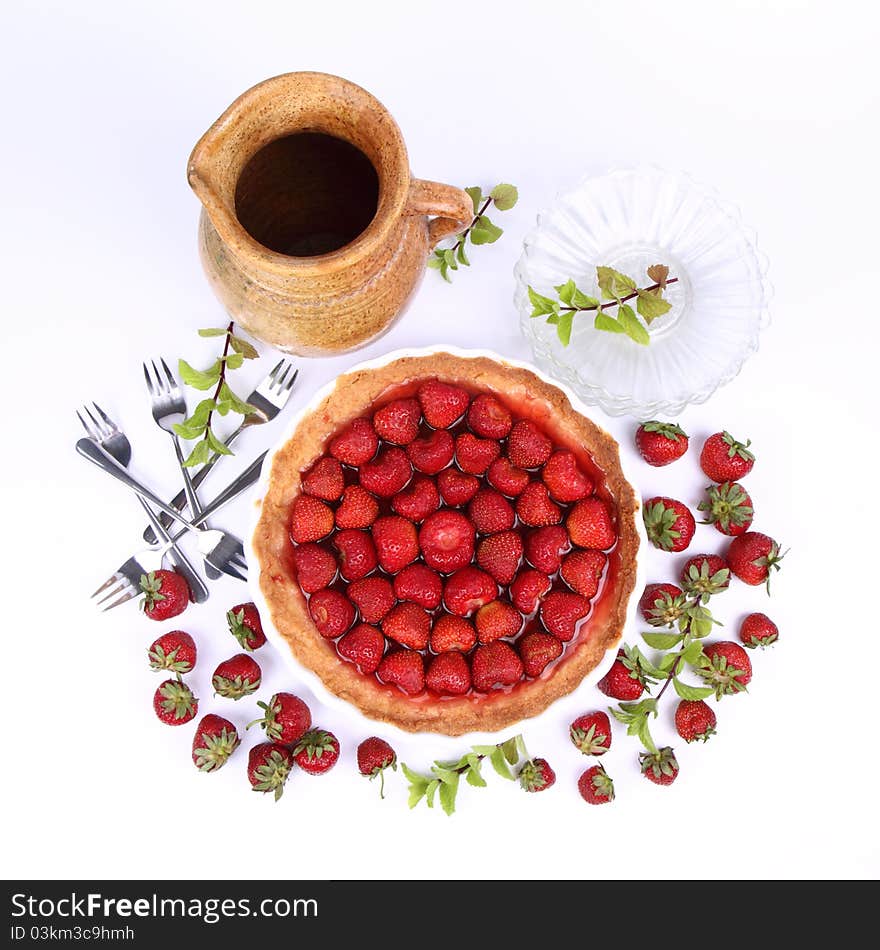 Strawberry Tart, plates, a pot, strawberries and mint twigs