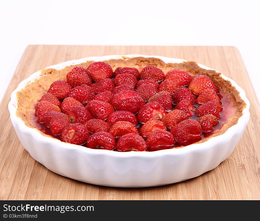 Strawberry Tart in a tart pan on a wooden background