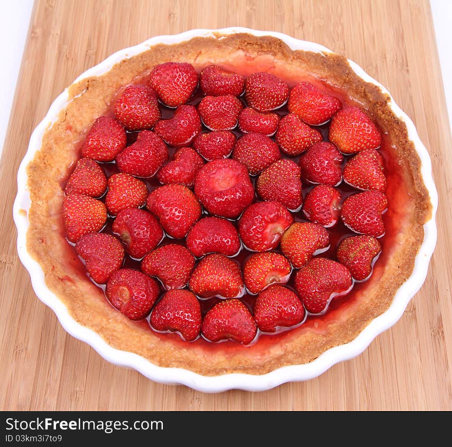 Strawberry Tart in a tart pan on a wooden background