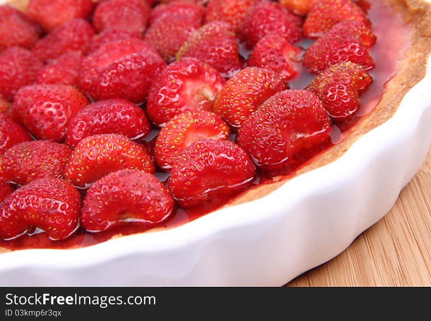 Strawberry Tart in a tart pan on a wooden background