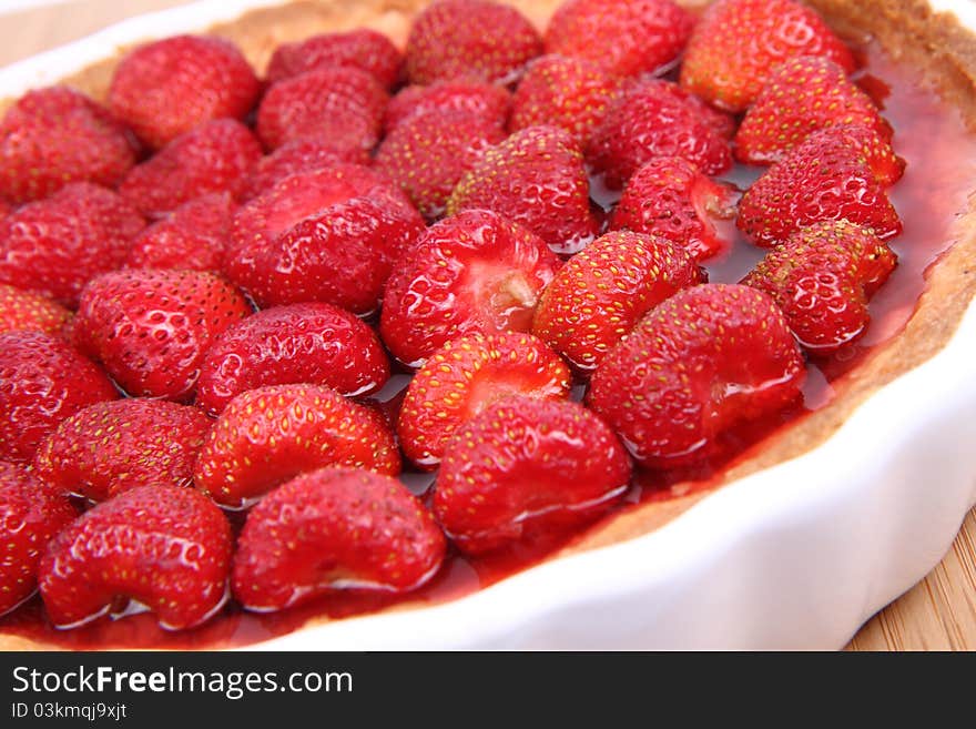 Strawberry Tart in a tart pan on a wooden background