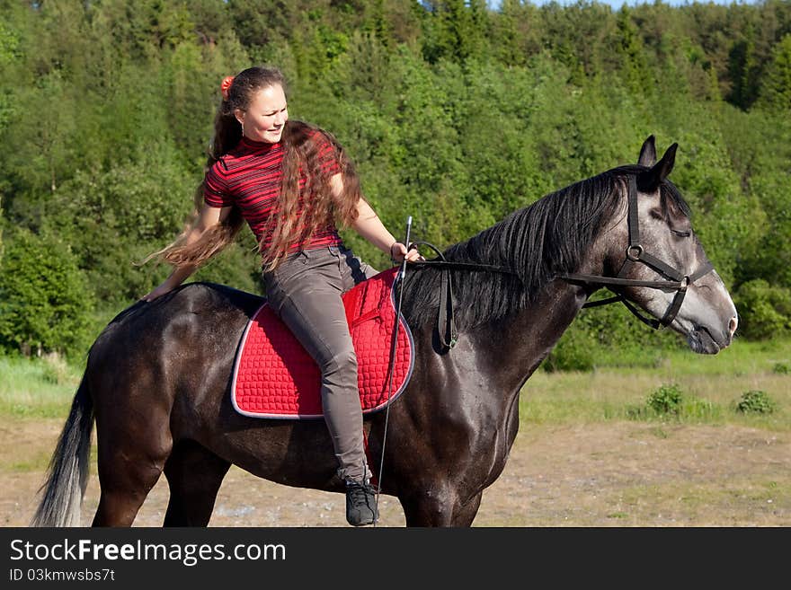 Beautiful girl on black horse