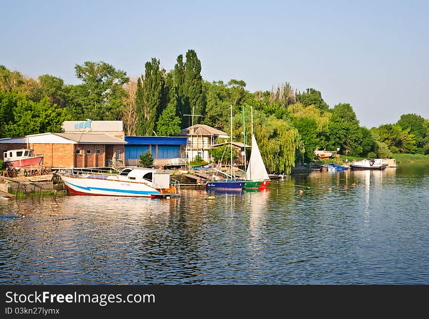 Boat station. The river, blue sky, boats on the river