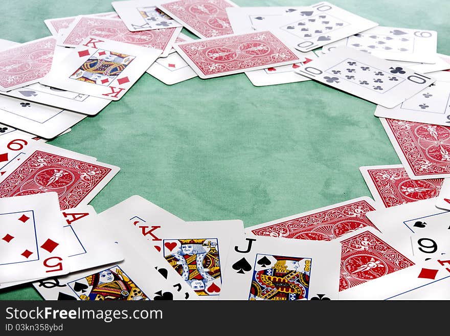 Close up view of a bunch cards spread on a green cloth table. Close up view of a bunch cards spread on a green cloth table.