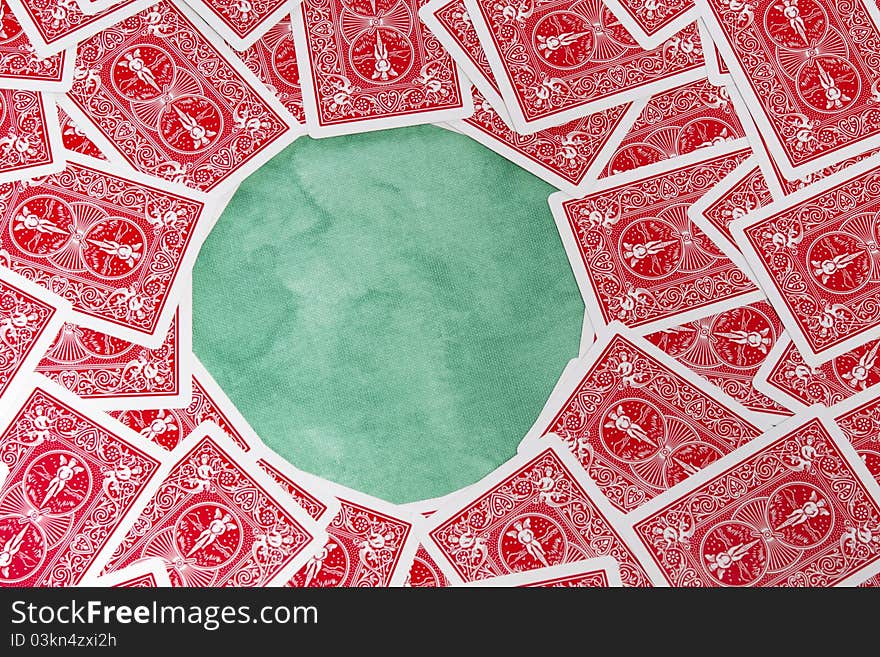 Close up view of a bunch of flipped playing cards spread on a green cloth table. Close up view of a bunch of flipped playing cards spread on a green cloth table.