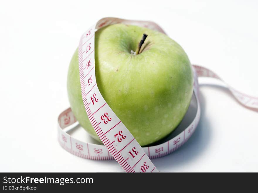 This is an image of apple with measuring tape. This is an image of apple with measuring tape.