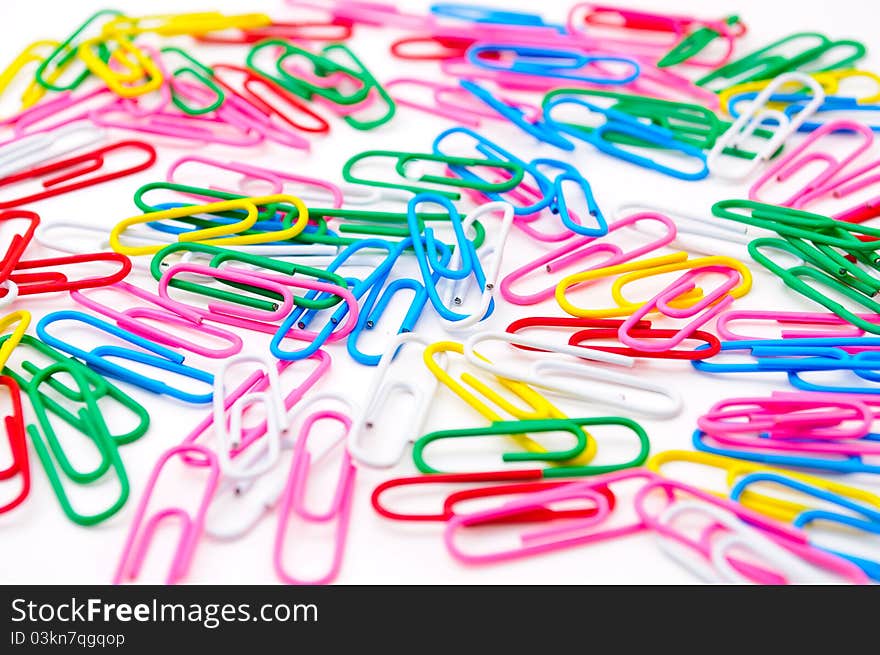 Colored paper clips. Isolated on white background