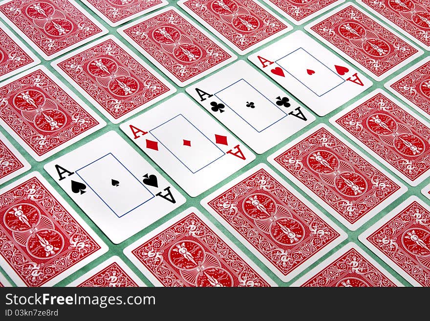 Close up view of a bunch of flipped playing cards spread on a green cloth table. Close up view of a bunch of flipped playing cards spread on a green cloth table.