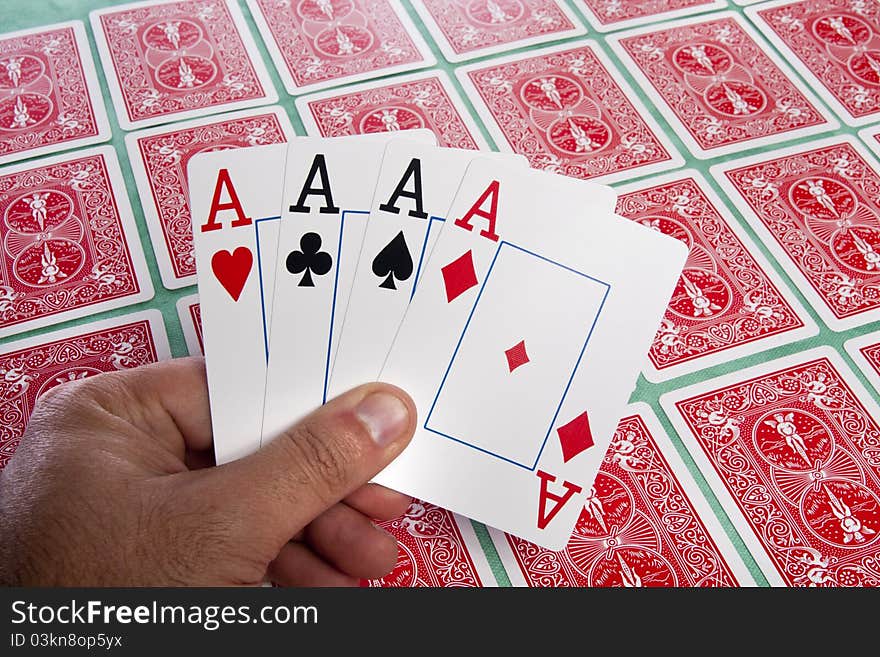 Close up view of a bunch of flipped playing cards spread on a green cloth table. Close up view of a bunch of flipped playing cards spread on a green cloth table.