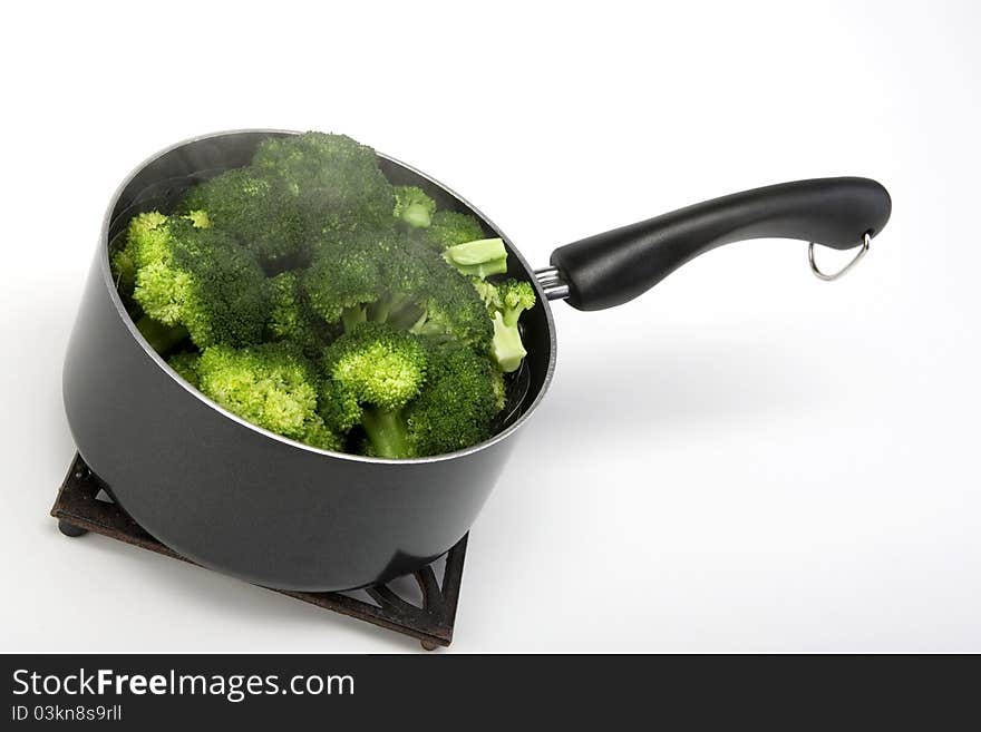 Steamed broccoli crowns in a pot. Steamed broccoli crowns in a pot