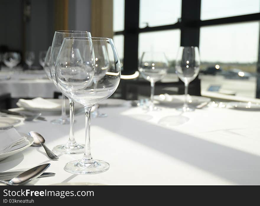 Glasses and plates on table in restaurant. Glasses and plates on table in restaurant