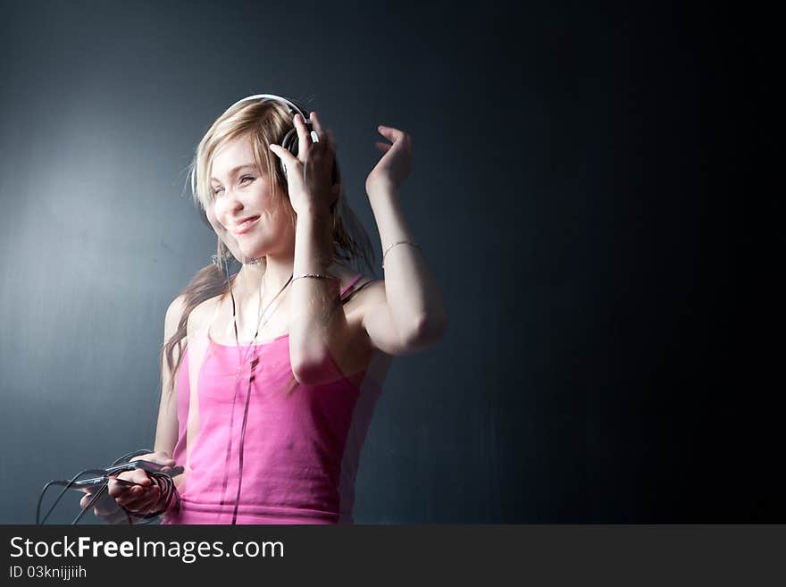 Music please! - Portrait of a pretty young woman/teenager listening to music on her hi-end headphones, enjoying the groove (multiple esposure shot)