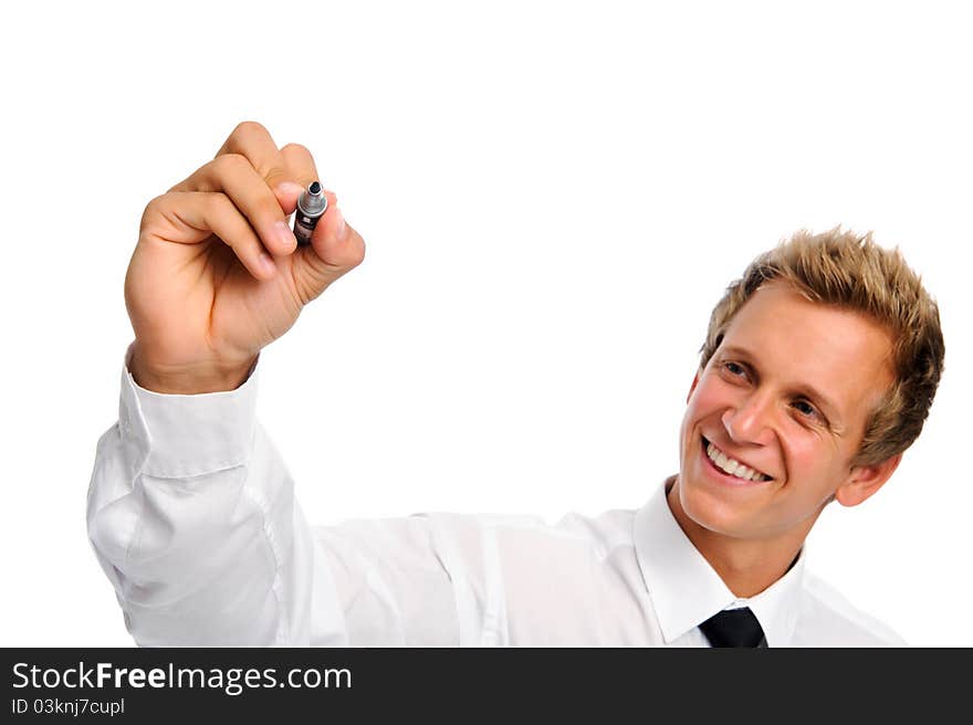 Good looking man in business attire holds a marker and writes in mid air. Good looking man in business attire holds a marker and writes in mid air